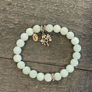 White beaded bracelet withh tree of life charm